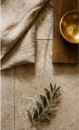 Natural material palette in Mediterranean interior design: linen, aged wood and brass with an olive branch